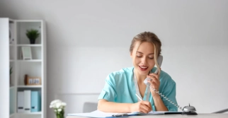 A female nurse talking to a telephone