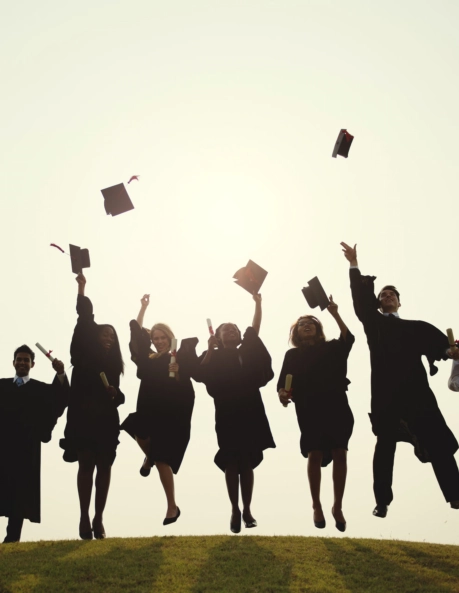 A group of graduates jumping together