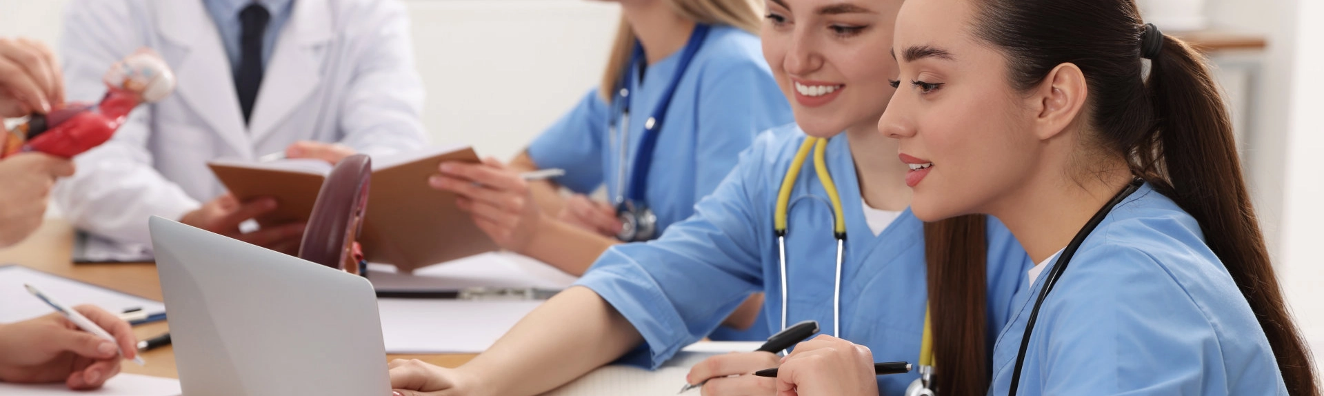 Two female nursing students looking at a computer