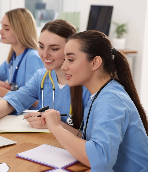 Two female nursing students looking at a computer