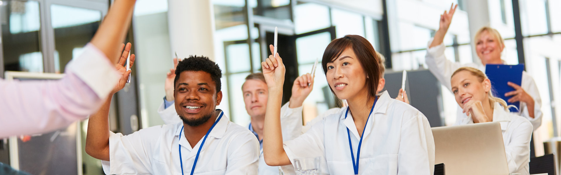 A group of medical students raising their hands